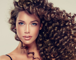 Brunette-girl-with-long-and-shiny-curly-hair-.-Beautiful-model-with-wavy-hairstyle-.-.jpg